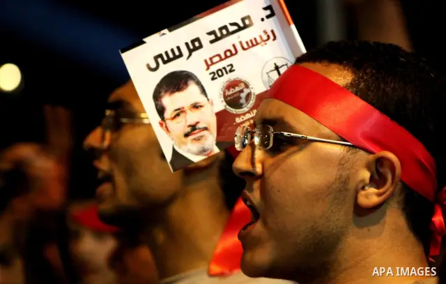 Supporters of the Muslim Brotherhood's presidential candidate Mohammed Mursi, unseen, hold a rally Cairo, Egypt, Sunday, May 20, 2012. Egypt's election commission is vowing that next week's presidential election will be...