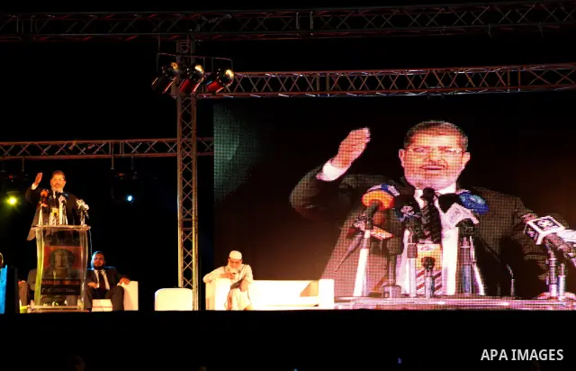 Mohamed Mursi, head of the Muslim Brotherhood's political party and the Brotherhood's presidential candidate, speaks during his last campaign rally in front of the Abdeen Palace Museum in Cairo May 20, 2012. Mursi has ca...