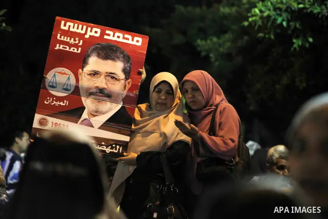 Supporters of the Muslim Brotherhood's presidential candidate Mohammed Mursi, unseen, hold a rally Cairo, Egypt, Sunday, May 20, 2012. Egypt's election commission is vowing that next week's presidential election will be...