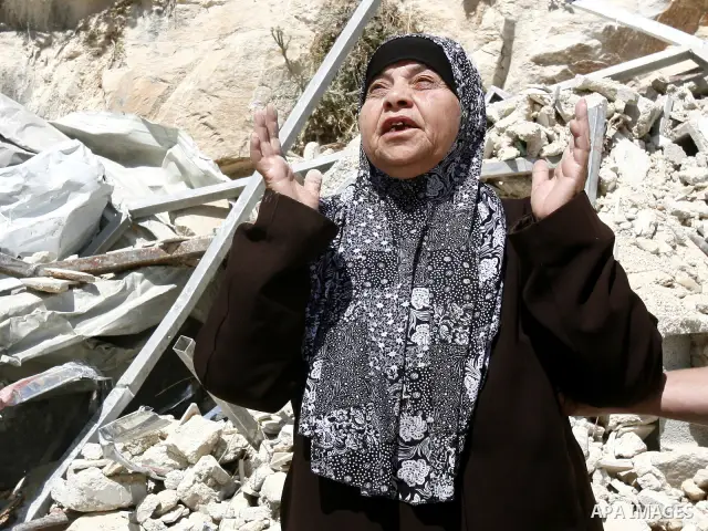 Palestinians survey the damage their house into the Jerusalem's old city on May 20, 2012. Thousands of Israelis marched into Jerusalem's old city to celebrate Jerusalem Day when the Jewish state captured the Arab eastern...