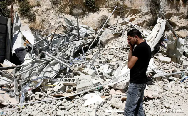 Palestinians survey the damage their house into the Jerusalem's old city on May 20, 2012. Thousands of Israelis marched into Jerusalem's old city to celebrate Jerusalem Day when the Jewish state captured the Arab eastern...