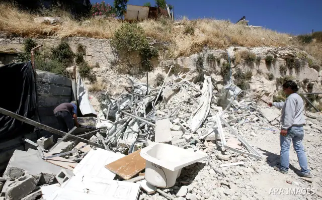 Palestinians survey the damage their house into the Jerusalem's old city on May 20, 2012. Thousands of Israelis marched into Jerusalem's old city to celebrate Jerusalem Day when the Jewish state captured the Arab eastern...