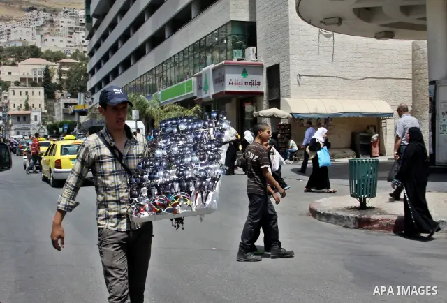 A Palestinian vendor displays sunglasses for sale in the West Bank city of Nablus,on May 21, 2012. Photo by Nedal Eshtayah