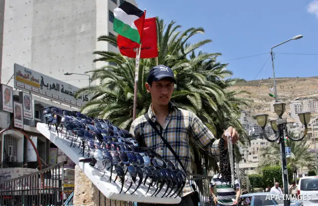 A Palestinian vendor displays sunglasses for sale in the West Bank city of Nablus,on May 21, 2012. Photo by Nedal Eshtayah