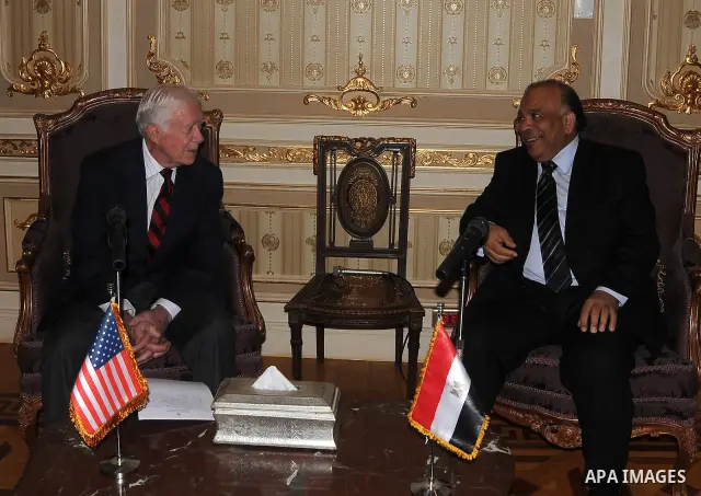 Egyptian Parliament Speaker Saad al-Katatni meets withs former US president Jimmy Carter in his office in Cairo on May 21, 2012. Carter had arrived the previous day in Egypt with a delegation from his Carter Center to mo...