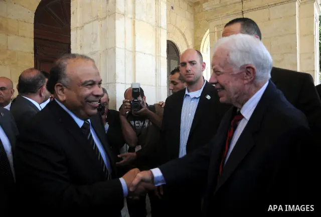 Egyptian Parliament Speaker Saad al-Katatni meets withs former US president Jimmy Carter in his office in Cairo on May 21, 2012. Carter had arrived the previous day in Egypt with a delegation from his Carter Center to mo...