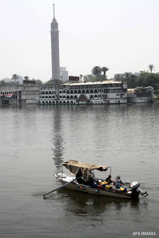 Egyptians men ride their boat through the Nile River in Cairo, Egypt, May 22, 2012, one day before the country's landmark presidential elections. Photo by Ashraf Amra