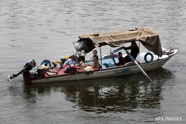 Egyptians ride their boat through the Nile River in Cairo, Egypt, May 22, 2012, one day before the country's landmark presidential elections. Photo by Ashraf Amra