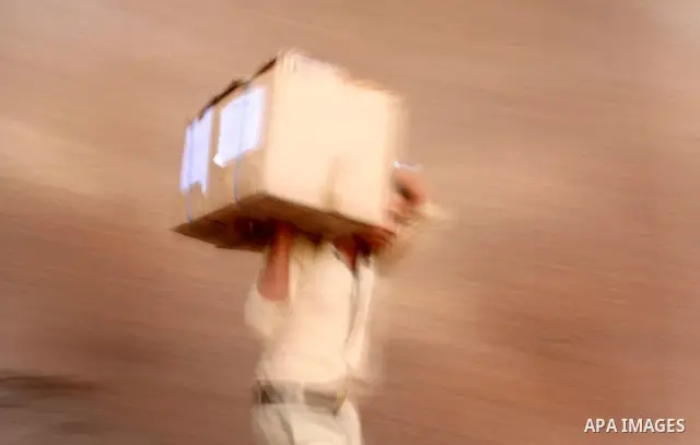 Egyptian soldiers carry cardboard boxes containing voting ballots in the capital Cairo on May 22, 2012, a day before the first presidential election since an uprising overthrew Hosni Mubarak. Around 50 million eligible v...