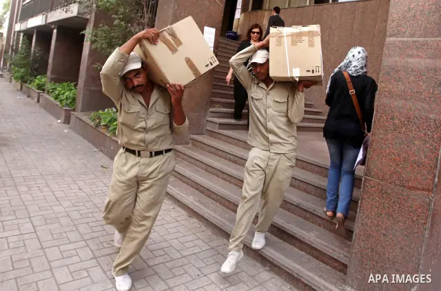 Egyptian soldiers carry cardboard boxes containing voting ballots in the capital Cairo on May 22, 2012, a day before the first presidential election since an uprising overthrew Hosni Mubarak. Around 50 million eligible v...