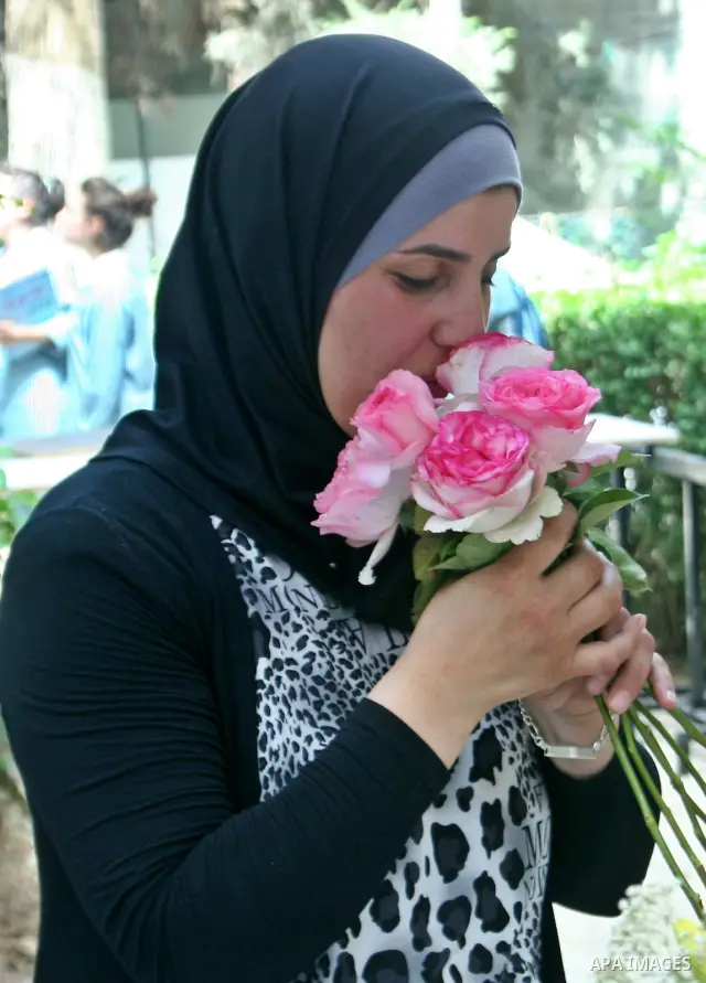 A Palestinian woman participates in the opening of Palestinian agricultural festival at strawberry and roses , in the West Bank city of Nablus on May 23, 2012. Photo by Nedal Eshtayah