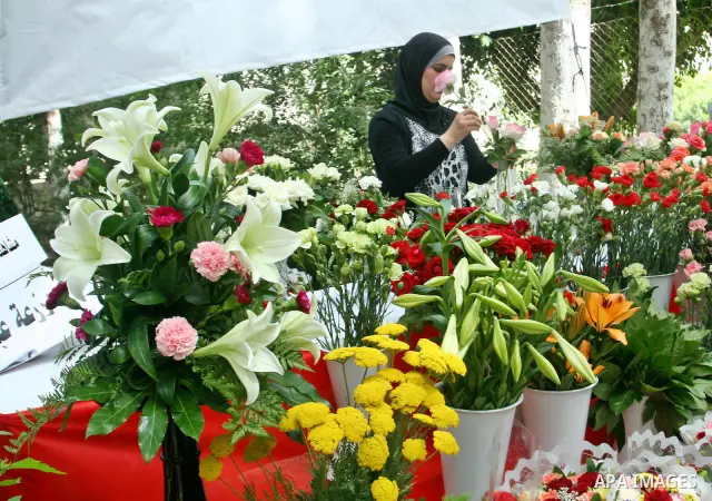 A Palestinian woman participates in the opening of Palestinian agricultural festival at strawberry and roses , in the West Bank city of Nablus on May 23, 2012. Photo by Nedal Eshtayah