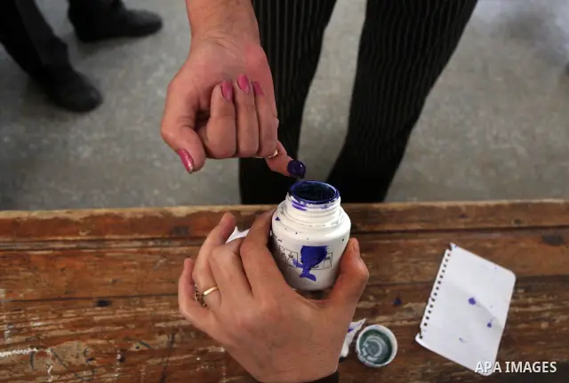 Egyptian voter dips his finger in the ink to cast his ballot during the first round of Egypt's presidential elections, at a polling station in Cairo, Egypt, 23 May 2012. Egyptian voters, on 23 May, queued at polling stat...