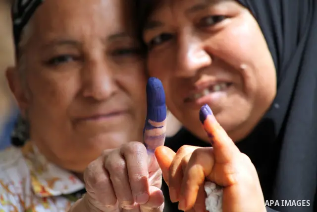 Egyptian women show the ink-marked finger after casting their ballot during the first round of Egypt's presidential elections, at a polling station in Cairo, Egypt, 23 May 2012. Egyptian voters, on 23 May, queued at poll...