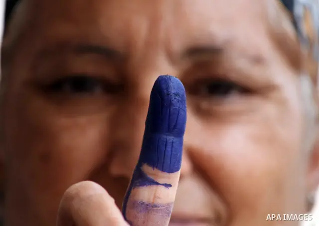 Egyptian woman shows her ink-marked finger after casting her ballot during the first round of Egypt's presidential elections, at a polling station in Cairo, Egypt, 23 May 2012. Egyptian voters, on 23 May, queued at polli...