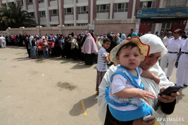Hundreds of voters line up in front of one of the polling stations to cast their votes on the first day of the presidential elections in Cairo, Egypt, 23 May 2012. Egyptian voters, on 23 May, queued at polling stations f...