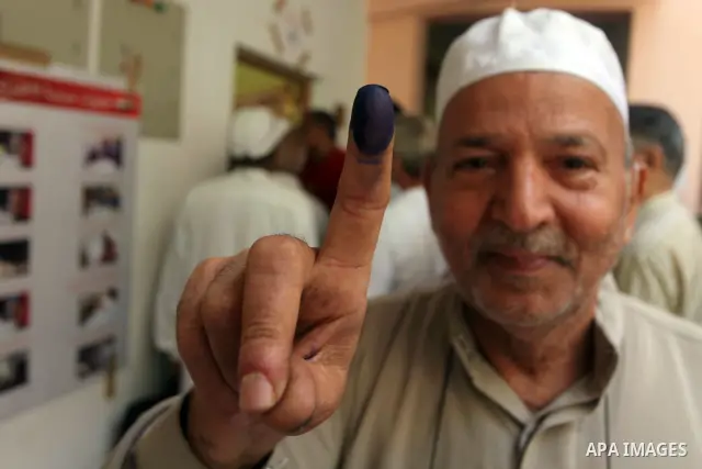 Egyptian man shows his ink-marked finger after casting his ballot during the first round of Egypt's presidential elections, at a polling station in Cairo, Egypt, 23 May 2012. Egyptian voters, on 23 May, queued at polling...