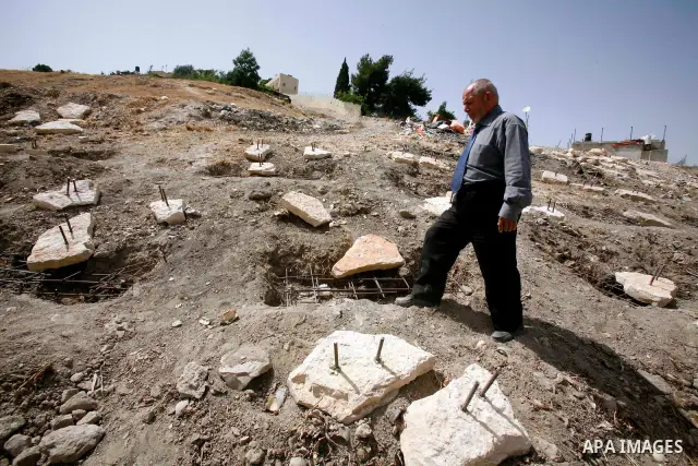 A Palestinian man walks on a land ready to be confiscated by israel authority as a cemetery for jewish in silwan Jerusalem's old city on May 23, 2012. Photo by Mahfouz Abu Turk