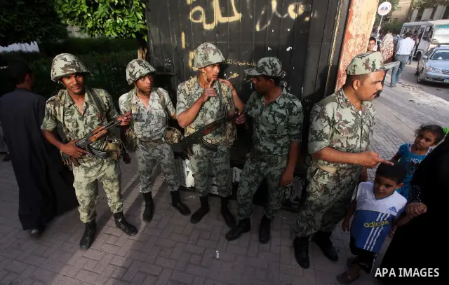 Egyptian security gards, stand in the front of one of the polling stations, on the first day of the presidential elections in Cairo, Egypt, 23 May 2012. Egyptian voters, on 23 May, queued at polling stations for the firs...