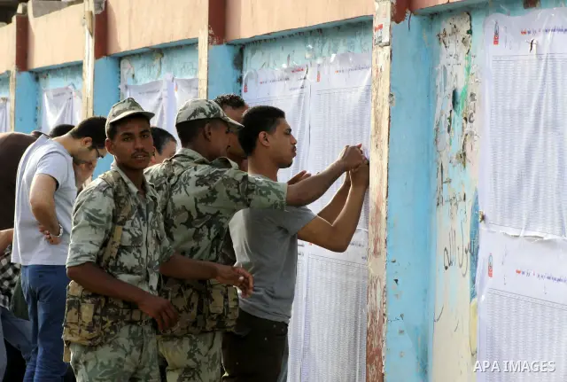 Egyptian voters search for their name outside a polling station to cast their votes on the first day of the presidential elections in Cairo, Egypt, 23 May 2012. Egyptian voters, on 23 May, queued at polling stations for...