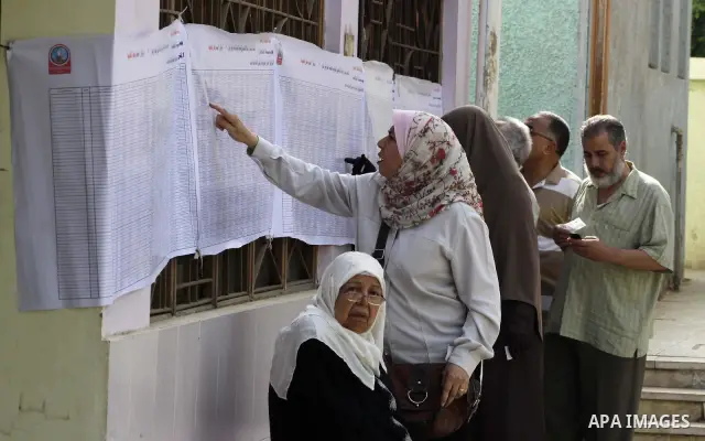 Egyptian voters search for their name outside a polling station to cast their votes on the first day of the presidential elections in Cairo, Egypt, 23 May 2012. Egyptian voters, on 23 May, queued at polling stations for...