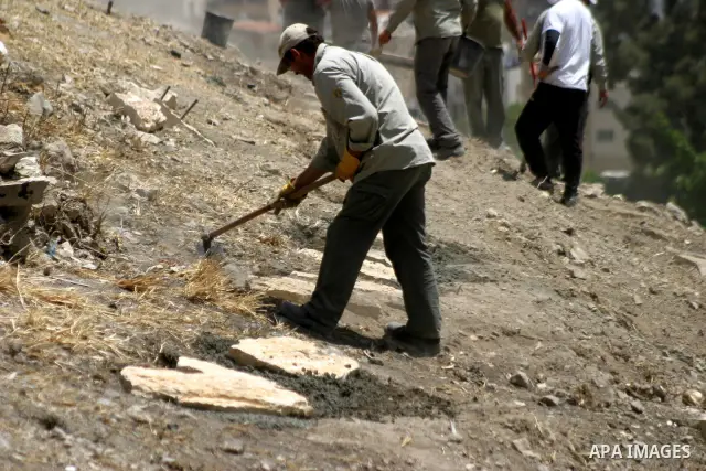Workers build fake tombs at the alleged Jewish graves in a Palestinian area outside of Jerusalem in order to Judaize the area, in Valley Rababa, in Silwan Jerusalem's old city on May 24, 2012. Photo by Mahfouz Abu Turk