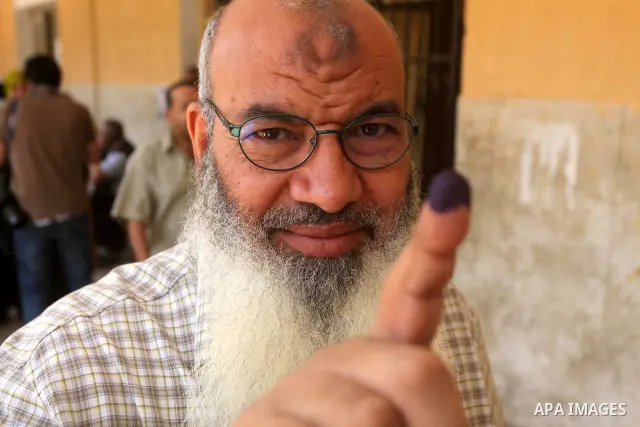 Egyptian man shows his ink-marked finger after casting his ballot during the first round of Egypt's presidential elections, at a polling station in Cairo, Egypt, 24 May 2012. for the first Presidential election since the...