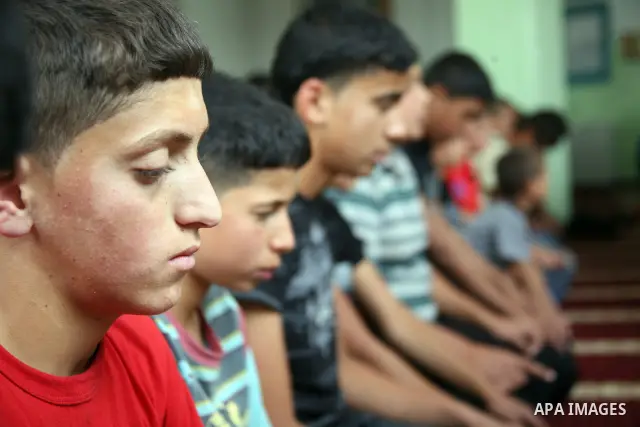 Palestinian orphan children pray at the Hebron's orphan house, in the West Bank city of Hebron 24 May 2012. Hebron's orphan house contain about 100 orphan children from ages 6 to 18 years old, and oversees some of orphan...