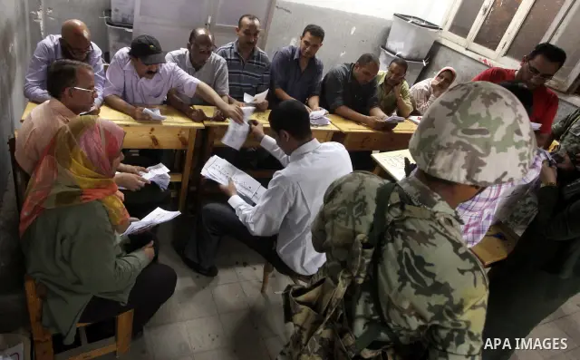 Egyptian election officials count ballots of the first round of Egypt's presidential elections, in a polling station in Cairo, Egypt, at the end of the election's second day on 24 May 2012. Polling stations closed at 9 p...