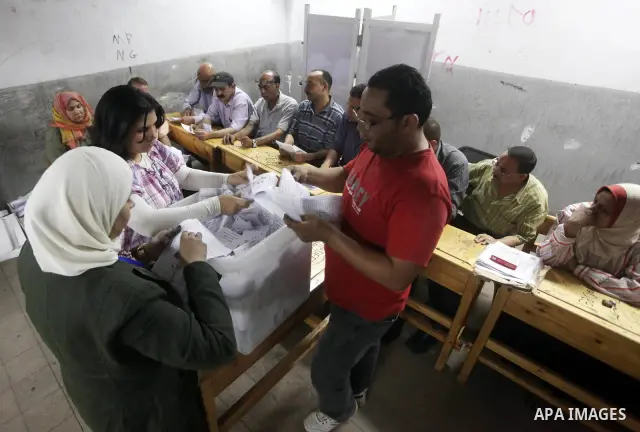 Egyptian election officials count ballots of the first round of Egypt's presidential elections, in a polling station in Cairo, Egypt, at the end of the election's second day on 24 May 2012. Polling stations closed at 9 p...