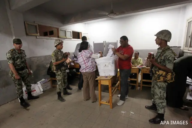 Egyptian election officials count ballots of the first round of Egypt's presidential elections, in a polling station in Cairo, Egypt, at the end of the election's second day on 24 May 2012. Polling stations closed at 9 p...