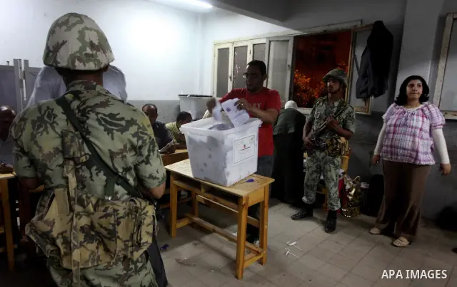 Egyptian election officials count ballots of the first round of Egypt's presidential elections, in a polling station in Cairo, Egypt, at the end of the election's second day on 24 May 2012. Polling stations closed at 9 p...