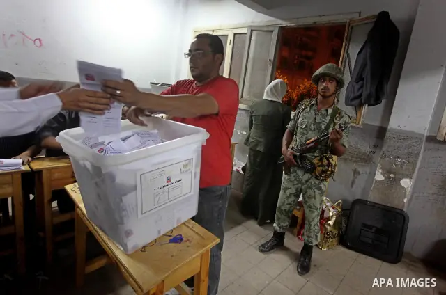 Egyptian election officials count ballots of the first round of Egypt's presidential elections, in a polling station in Cairo, Egypt, at the end of the election's second day on 24 May 2012. Polling stations closed at 9 p...