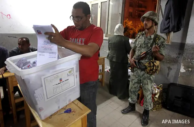 Egyptian election officials count ballots of the first round of Egypt's presidential elections, in a polling station in Cairo, Egypt, at the end of the election's second day on 24 May 2012. Polling stations closed at 9 p...