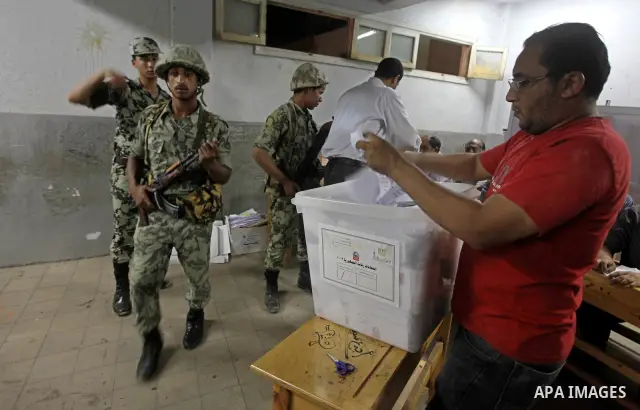 Egyptian election officials count ballots of the first round of Egypt's presidential elections, in a polling station in Cairo, Egypt, at the end of the election's second day on 24 May 2012. Polling stations closed at 9 p...