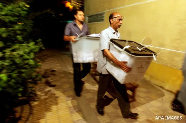 Egyptian election officials take sealed ballet boxs to count ballots of the first round of Egypt's presidential elections, in a polling station in Cairo, Egypt, at the end of the election's second day on 24 May 2012. Pol...