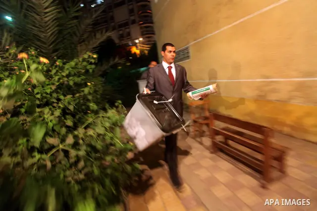 Egyptian election officials take sealed ballet boxs to count ballots of the first round of Egypt's presidential elections, in a polling station in Cairo, Egypt, at the end of the election's second day on 24 May 2012. Pol...