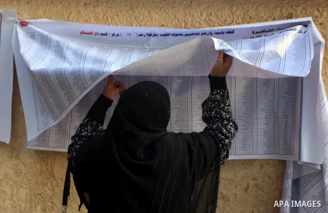 An Egyptian voter searches for his name outside a polling station to cast their votes on the first day of the presidential elections in Cairo, Egypt, 24 May 2012. Egyptian voters, on 24 May, queued at polling stations fo...