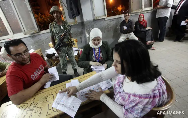 Egyptian election officials count ballots of the first round of Egypt's presidential elections, in a polling station in Cairo, Egypt, at the end of the election's second day on 24 May 2012. Polling stations closed at 9 p...