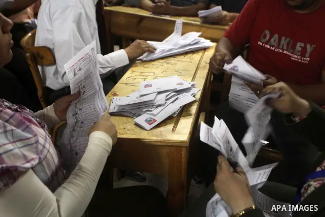 Egyptian election officials count ballots of the first round of Egypt's presidential elections, in a polling station in Cairo, Egypt, at the end of the election's second day on 24 May 2012. Polling stations closed at 9 p...