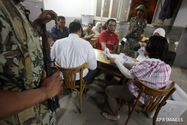 Egyptian election officials count ballots of the first round of Egypt's presidential elections, in a polling station in Cairo, Egypt, at the end of the election's second day on 24 May 2012. Polling stations closed at 9 p...