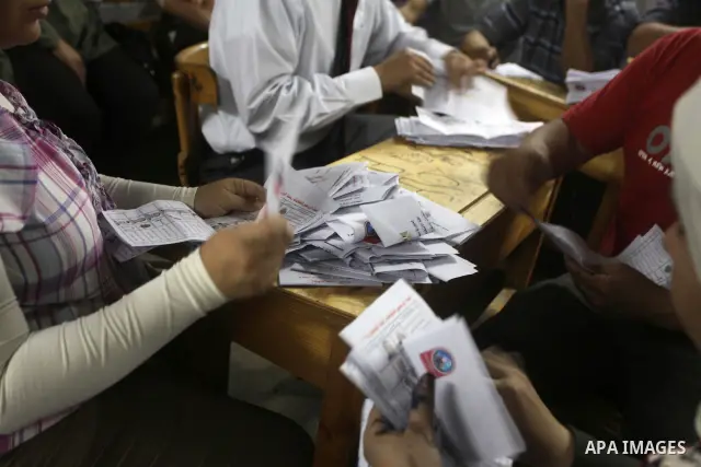 Egyptian election officials count ballots of the first round of Egypt's presidential elections, in a polling station in Cairo, Egypt, at the end of the election's second day on 24 May 2012. Polling stations closed at 9 p...