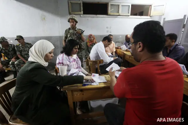 Egyptian election officials count ballots of the first round of Egypt's presidential elections, in a polling station in Cairo, Egypt, at the end of the election's second day on 24 May 2012. Polling stations closed at 9 p...