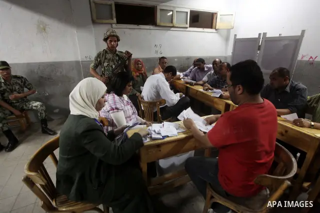 Egyptian election officials count ballots of the first round of Egypt's presidential elections, in a polling station in Cairo, Egypt, at the end of the election's second day on 24 May 2012. Polling stations closed at 9 p...
