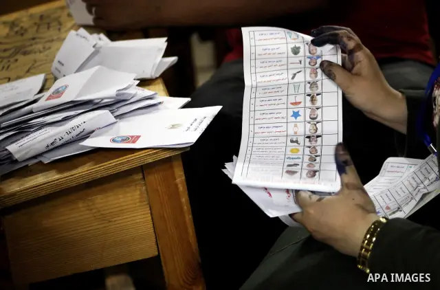 Egyptian election officials count ballots of the first round of Egypt's presidential elections, in a polling station in Cairo, Egypt, at the end of the election's second day on 24 May 2012. Polling stations closed at 9 p...