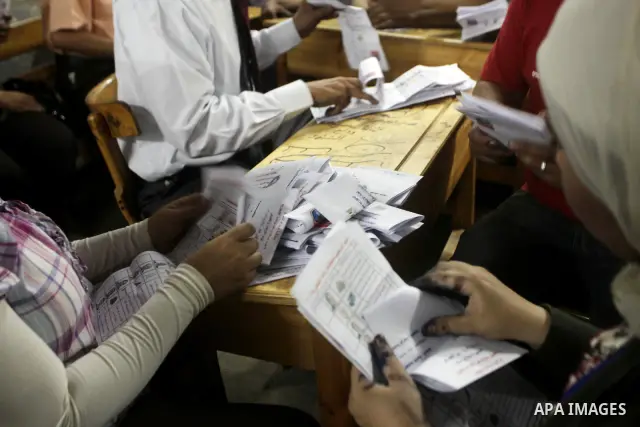 Egyptian election officials count ballots of the first round of Egypt's presidential elections, in a polling station in Cairo, Egypt, at the end of the election's second day on 24 May 2012. Polling stations closed at 9 p...