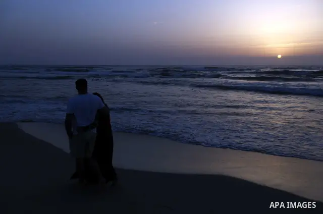 Palestinians enjoy at the beach during sunset in Gaza City on May 24, 2012. Gaza beach is the only outlet for the Palestinians after tightening the Israeli blockade on the Gaza Strip. Photo by Majdi Fathi