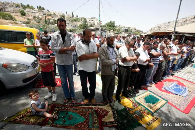 Palestinian Muslim worshippers attend Friday prayers outside a protest tent against the continuing 'Judaization of Jerusalem' by Jewish settlers, in the mostly Arab neighbourhood of Silwan in east Jerusalem on May 25, 20...