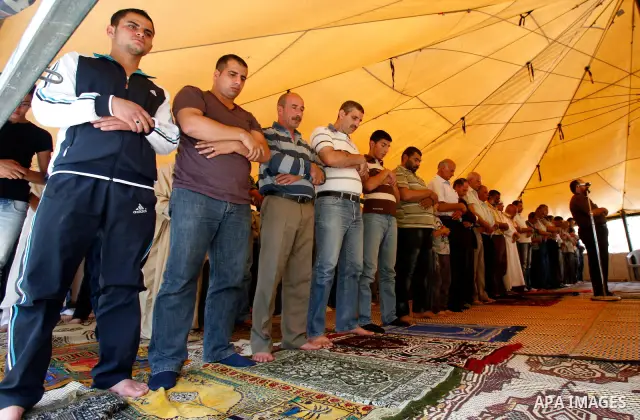 Palestinian Muslim worshippers attend Friday prayers inside a protest tent against the continuing 'Judaization of Jerusalem' by Jewish settlers, in the mostly Arab neighbourhood of Silwan in east Jerusalem on May 25, 201...