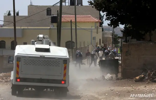 Israeli truck spray foul smelling water towards Palestinian protesters during clashes in the northern West Bank village of Kufr Qaddum, near the Jewish settlement of Kdumim, on May 25, 2012. Photo by Wagdi Eshtayah